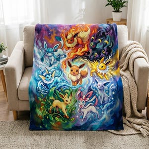 May include: A rectangular fleece throw blanket featuring a vibrant, colourful illustration of nine Eevee evolution characters arranged in a circular pattern against a swirling, cosmic background of fire, water, electricity, and magical energy.