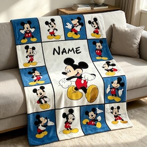 May include: A soft fleece blanket featuring a grid pattern of Mickey Mouse in various poses against blue and white backgrounds. The center panel displays a large Mickey Mouse graphic and the word NAME in black, bold, sans-serif capital letters.