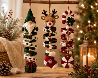 May include: Three hanging crochet Christmas ornaments suspended from a wooden rod. The left features a gnome with a green hat and a gift base. The centre shows a reindeer head above a red stocking. The right displays a candy cane and peppermint.