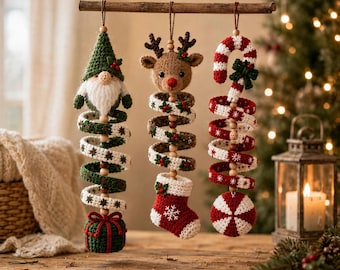 May include: Three hanging crochet ornaments suspended from a wooden branch. The first is a gnome with a green hat and gift box base. The second is a reindeer head with a stocking base. The third is a candy cane with a peppermint base.