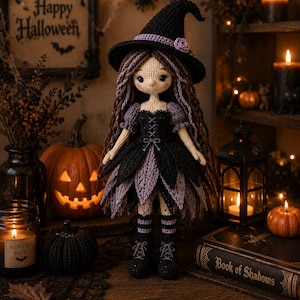 May include: A crocheted doll dressed as a witch, featuring long brown hair, a black pointed hat with a lavender band, and a layered black and lavender dress. The doll wears black lace-up boots and striped socks, with a light beige complexion.