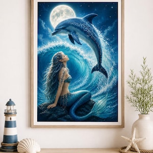 Könnte beinhalten: Ein gerahmter Kunstdruck, der eine Meerjungfrau mit langem blauem Haar zeigt, die auf einem dunklen Felsen sitzt und zu einem Delfin aufblickt, der unter einem hellen Vollmond in einem sternenklaren Nachthimmel aus einer Welle springt.