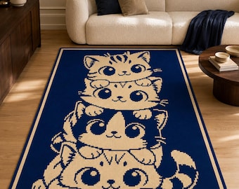 May include: A rectangular area rug featuring a deep blue background with a cream-colored graphic print of four stacked kittens. The design displays a vertical arrangement of feline faces with large eyes and whiskers, bordered by a simple cream frame.