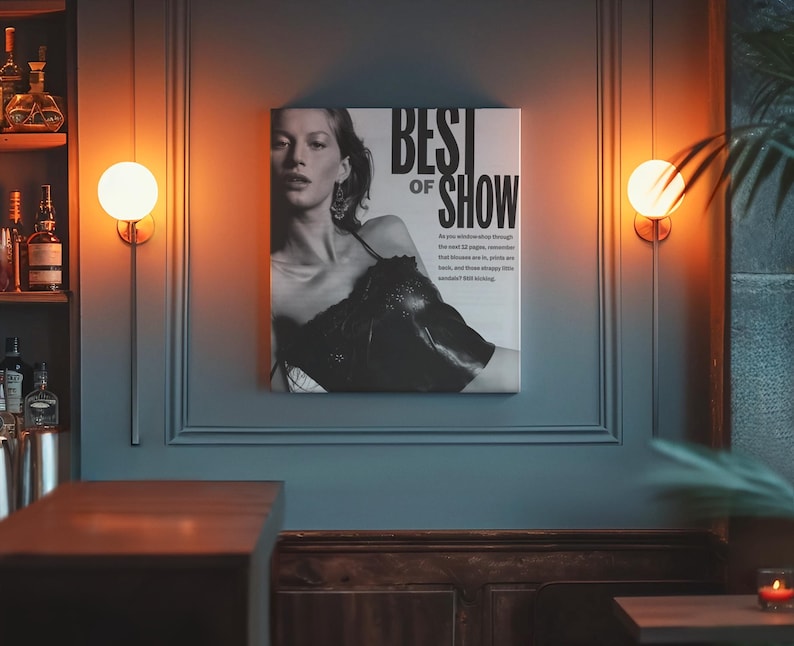 May include: A square black and white wall art print featuring a portrait of a person wearing a dark top. The text BEST OF SHOW is printed in large bold letters at the top right, followed by smaller text describing fashion trends.