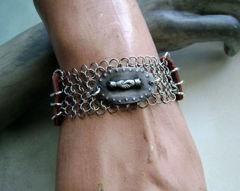 clasped hands motif bracelet with leather and chainmaille by AnvilArtifacts