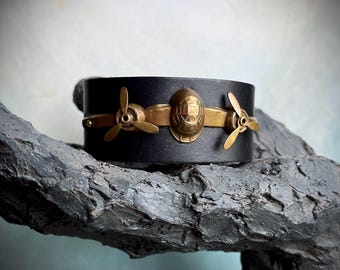 vintage brass propeller airplane on black leather bracelet by AnvilArtifacts, kinetic jewelry