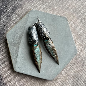 Medieval inspired mixed metal earrings with patterned verdigris spikes and metal cameos by Anvil Artifacts,