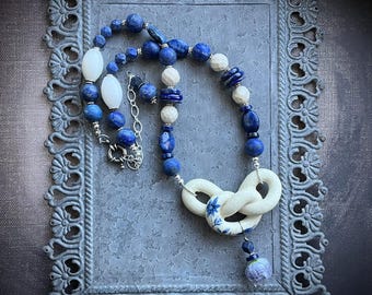 Flower and bow blue and white necklace with lapis lazuli by AnvilArtifacts