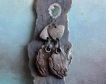 asymmetrical ceramic fossil fish with textured sterling silver shield earrings by AnvilArtifacts