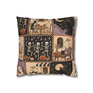 May include: A square throw cushion featuring a patchwork design with Halloween-themed illustrations. The print includes dancing skeletons, goats drinking coffee at tables, black cats wearing witch hats, pumpkins, ghosts, and a full moon.