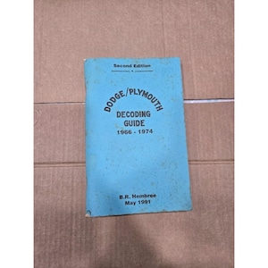 May include: A light blue softcover book titled Dodge/Plymouth Decoding Guide 1966-1974, Second Edition, by B.R. Hembree, May 1991. The front cover features black text printed on a light blue background with visible signs of age and wear.