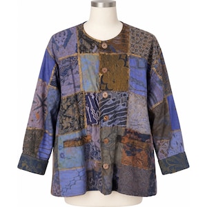 May include: A long-sleeve button-down jacket featuring a patchwork design with various blue, brown, and purple fabric squares. The garment has a round neckline, five brown buttons down the center front, and wide cuffs on the sleeves.