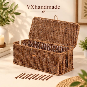 May include: A rectangular brown woven wicker storage basket with an attached hinged lid and a vertical side opening. The text VXhandmade is visible above the basket, accompanied by a small leaf icon. Ten small brown rectangular tabs are arranged below.