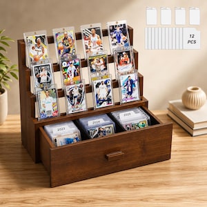 May include: A dark brown wooden tiered display stand featuring three rows for upright sports trading cards in protective cases and a bottom drawer containing three rows of cards with labels marked 2023, 2024, and 2025. Includes 12 clear card sleeves.