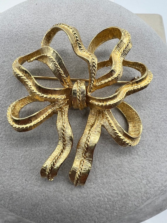 Vintage signed Monet Textured Gold Ribbon Bow Broo