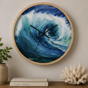 May include: A round wall clock with a light wood frame featuring a painted ocean wave design in shades of deep blue, turquoise, and white. The clock face has three thin black hands positioned against the swirling water imagery.