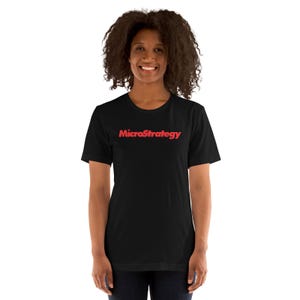 May include: A black short-sleeved t-shirt featuring the word MicroStrategy printed in a bold red font across the center of the chest. The garment has a classic crew neckline and a straight hemline, providing a simple and clean appearance.
