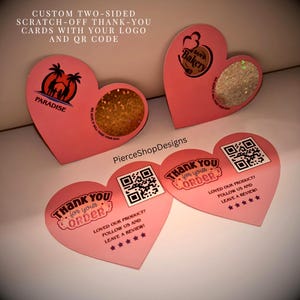 May include: Heart-shaped pink thank-you cards featuring custom logos, QR codes, and circular scratch-off areas. The text reads: CUSTOM TWO-SIDED SCRATCH-OFF THANK-YOU CARDS WITH YOUR LOGO AND QR CODE, THANK YOU for your ORDER, and PierceShopDesigns.