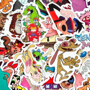 May include: A collection of colorful vinyl stickers featuring various cartoon characters from 1990s television shows, including Ren and Stimpy, the Rugrats, and other animated figures, arranged in a dense, overlapping collage of individual die-cut designs.