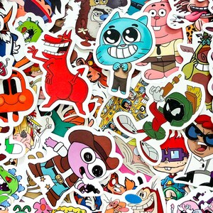 May include: A collection of assorted vinyl stickers featuring various colorful cartoon characters, including a blue cat, a red devil-like figure, a green alien in a helmet, and a purple character wearing a brown cowboy hat and holding a gun.