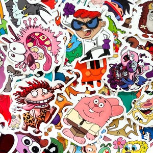 May include: A collection of colorful vinyl stickers featuring various cartoon characters including Dexter, Courage the Cowardly Dog, Donnie Thornberry, Richard Watterson, and SpongeBob SquarePants, all arranged in a dense, overlapping collage.