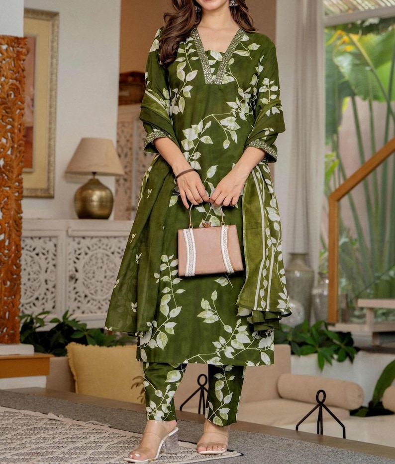 Pu&ograve; includere: Un completo a tre pezzi color verde oliva composto da una tunica a maniche lunghe con scollo a V, pantaloni abbinati e una sciarpa coordinata, il tutto decorato con un motivo a foglie bianche. Lo scollo della tunica presenta decorazioni argentate.