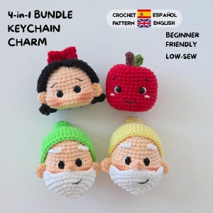 May include: A 4-in-1 bundle crochet pattern for keychain charms, featuring four small plush heads: one with black hair and a red bow, a red apple, and two bearded figures wearing green and yellow hats. Text includes Beginner Friendly and Low-Sew.