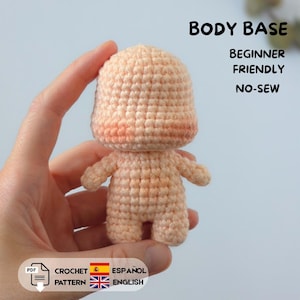 May include: A small, peach-coloured crochet doll body base with a rounded head and simple limbs. The text on the image reads: BODY BASE, BEGINNER FRIENDLY, NO-SEW, PDF CROCHET PATTERN, ESPAÑOL, ENGLISH. The doll is crafted with a visible yarn stitch texture.
