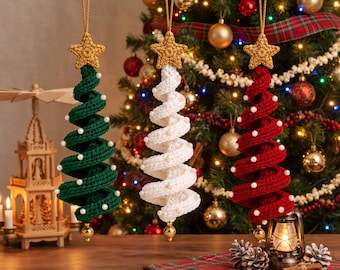 May include: Three spiral-shaped Christmas tree ornaments made of crocheted yarn in dark green, white, and deep red. Each ornament features a gold-colored crocheted star at the top, a gold hanging loop, and small white beads along the spiral edges.