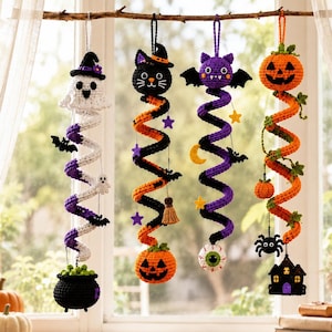 May include: Four hanging crochet decorations for Halloween. The first features a white ghost and a black cauldron. The second has a black cat and an orange pumpkin. The third shows a purple bat, a yellow moon, and an eyeball. The fourth displays an orange pumpkin and a black house.