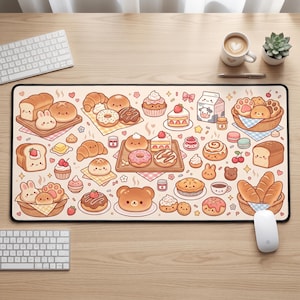 May include: A rectangular desk mat featuring a repeating pattern of various illustrated baked goods, including bread loaves, donuts, cupcakes, and pastries with smiling faces, interspersed with small icons of milk cartons, jars, and cherries on a light background.