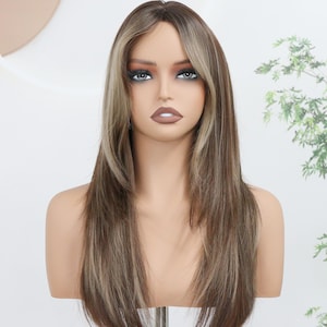 May include: A long, layered synthetic wig featuring a dark brown base with lighter ash blonde highlights and face-framing curtain bangs. The hair is straight, smooth, and styled with a center part, displayed on a mannequin head with neutral features.
