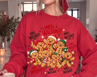 パーソナライズされたジンジャーブレッドクリスマス教師用シャツ、コンフォートカラーズカスタム教師名入りTシャツ、かわいいホリデー教室用Tシャツ
