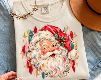 ヴィンテージサンタクロースクリスマスTシャツ、レトロなクリスマスTシャツ（女性用）、ウィンクするパステルカラーのホリデー衣装、水彩画風グラフィック、コンフォートカラーのギフトアイデア