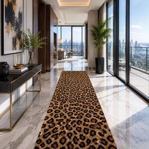 May include: A long, rectangular runner rug featuring a repeating leopard print pattern in shades of brown, tan, and black. The rug is positioned centrally on a polished white marble floor within a bright, modern hallway with floor-to-ceiling windows.