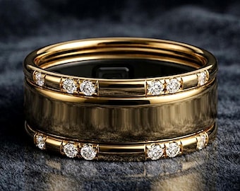 May include: A wide gold band ring featuring a smooth, polished center section flanked by two thinner outer bands. Each outer band is set with a series of small, round, clear, sparkling stones that encircle the entire circumference of the ring.