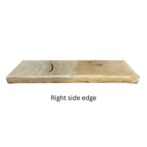 Op de afbeelding: Een rechthoekig canvaspaneel met een lichtbeige en bruine afwerking. De linkerkant is voorzien van een reeks concentrische cirkelvormige penseelstreken in een lichtere tint, terwijl de rechterkant een kleine, donkere, handgetekende ster bevat.
