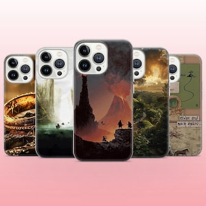 May include: Five smartphone cases featuring fantasy-themed illustrations. Designs include a glowing gold ring, a river landscape, a volcanic mountain scene with silhouettes, a lush green valley at sunset, and a map with the text There and back again.