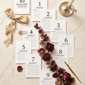 May include: Ten white rectangular cards labeled 1 through 10 with the text Reasons Why I Love You and blank lines for writing. The set includes a gold ribbon, a gold candle holder with a taper candle, a gold paperclip, a wax seal, and a gold pen.