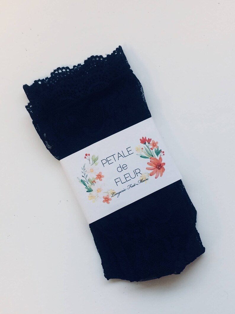 May include: Black lace lingerie with a white tag that reads "PETALE de FLEUR Lingerie Fait-Main".