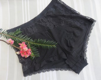 May include: Black lace underwear with a wide elastic waistband and a delicate lace trim. The underwear is made of a soft, stretchy fabric.
