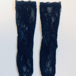 May include: A pair of black lace stockings with a floral pattern.