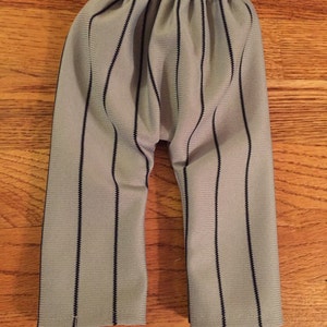 May include: Gray and black striped pants with a gathered elastic waistband.