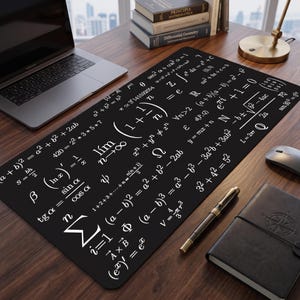 May include: A rectangular black desk mat featuring a white print of various mathematical formulas and equations, including limits, summations, and geometric identities, covering the entire surface of the mat in a repeating, organized pattern.
