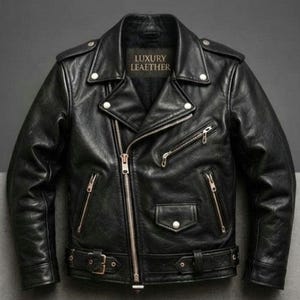 May include: A black leather motorcycle jacket featuring a wide notched collar with silver-tone snap buttons, an asymmetrical front zipper, multiple zippered pockets, a small flap pocket, and a buckled waist belt. The inner label reads LUXURY LEAETHER.
