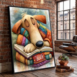 May include: A framed wall art print featuring a tan dog with closed eyes resting its head on an open book. The dog is wrapped in a colorful patterned blanket. Below the open book, a stack of books includes one with the text "They're all BOOK".