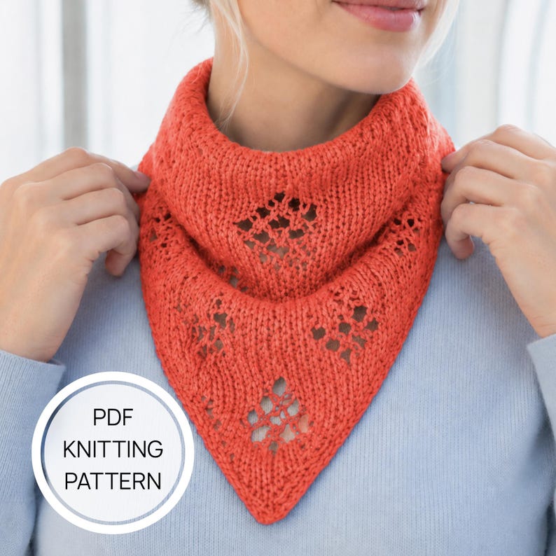 May include: A bright orange triangular knit cowl featuring a delicate lace diamond pattern throughout the fabric. A circular white badge in the bottom left corner contains the black text PDF KNITTING PATTERN, indicating the item is a digital file.