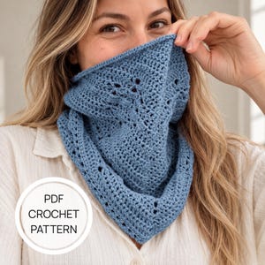 May include: A dusty blue triangular crochet bandana featuring a textured stitch pattern with small eyelet details along the edges. A circular white graphic overlay in the bottom left corner contains the black text PDF CROCHET PATTERN.