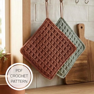 May include: Two square crochet potholders with a waffle stitch texture, one in terracotta and one in sage green, each featuring a leather hanging loop. The image includes the text PDF CROCHET PATTERN.