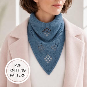 May include: A blue knitted triangular scarf featuring a ribbed collar and a series of diamond-shaped eyelet lace patterns. A circular white badge in the lower left corner contains the black text PDF KNITTING PATTERN.